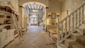 A spacious hallway with a wooden staircase, a bookshelf, and a chandelier. - Stunning, romantic 1 Bedroom Property With Terrace (Fornalutx)