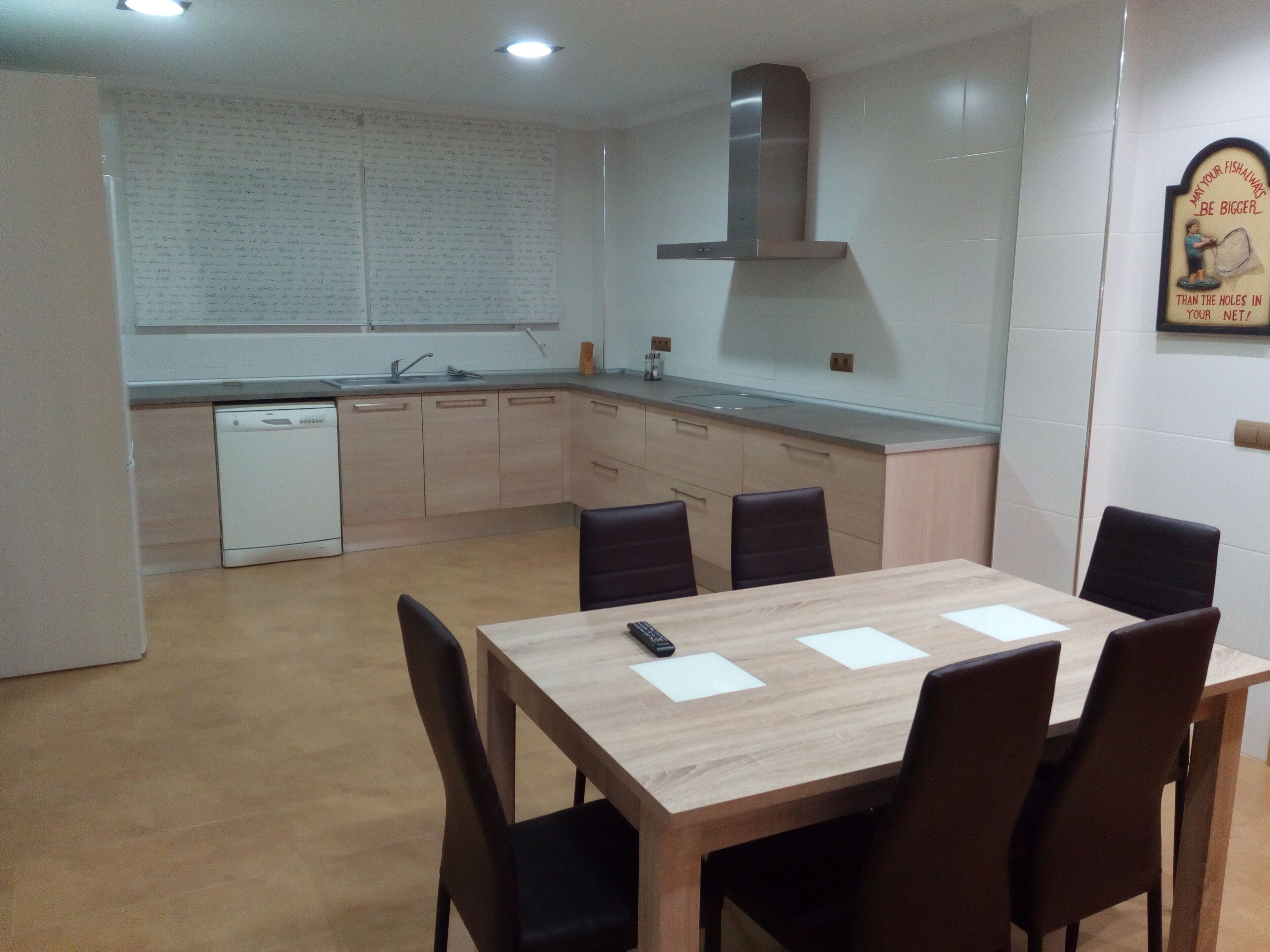 A modern kitchen with a dining area.