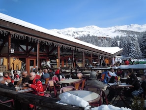 Enjoy meals with a breathtaking view of snow-covered peaks from this resort's outdoor dining area.