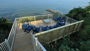 A deck with blue chairs and a table overlooking a body of water. - Lake Michigan Home with gorgeous views, great spot for family or golf retreat (Sheboygan)