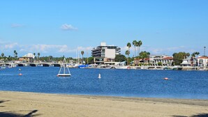 A marina with boats, a bridge, and buildings along the waterfront. - Bixby Beauty 50s Mod -- Pool and Parking (Long Beach)