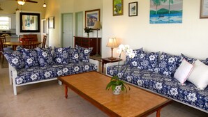 A living room with two sofas, a coffee table, and a dining area with chairs and a table. - Brigadoon: A beautiful Villa In Red Hook sleeps 6 studio is available to rent 2 (St. Thomas)