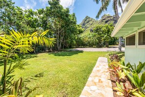 Escape to a tranquil oasis surrounded by lush greenery and majestic mountains.