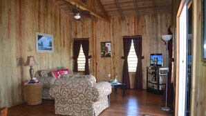 A wooden interior with a sofa, a television, and a lamp. - !Romantic Getaway Or Small Family Fun Time! Hill View Cabins. (Jonesville)