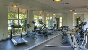 A gym with treadmills, elliptical machines, and free weights. - Incredible Ocean Views! Luxury 2BD in Heart of South Beach & Steps to the Sand! (Miami Beach)