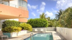 A rooftop pool area with lounge chairs and a clear blue sky. - Incredible Ocean Views! Luxury 2BD in Heart of South Beach & Steps to the Sand! (Miami Beach)
