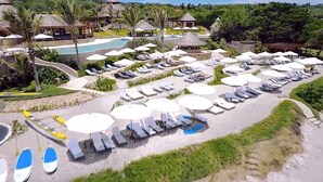 A resort with multiple pools, sun loungers, and umbrellas.