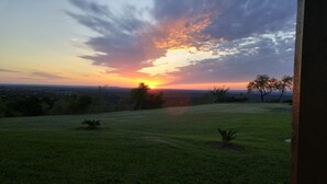 A grassy field with a sunset in the background. - VIEWS! Texas Hill Country - Terra Vista (Dripping Springs)