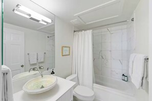 Combined shower/bathtub, hair dryer, towels, soap