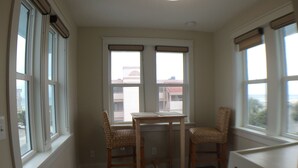 A corner room with two windows, a table, and two wicker chairs. - Steps to the non-driving section of the beach!  (Saint Augustine Beach)