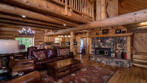 A log cabin interior with a living room, fireplace, kitchen, and a balcony. - Fabulous Log Home - 2 Master Bedrooms! (Tabernash)