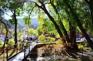 A park with a bridge, trees, and a building with a sign that reads "CINEMA".