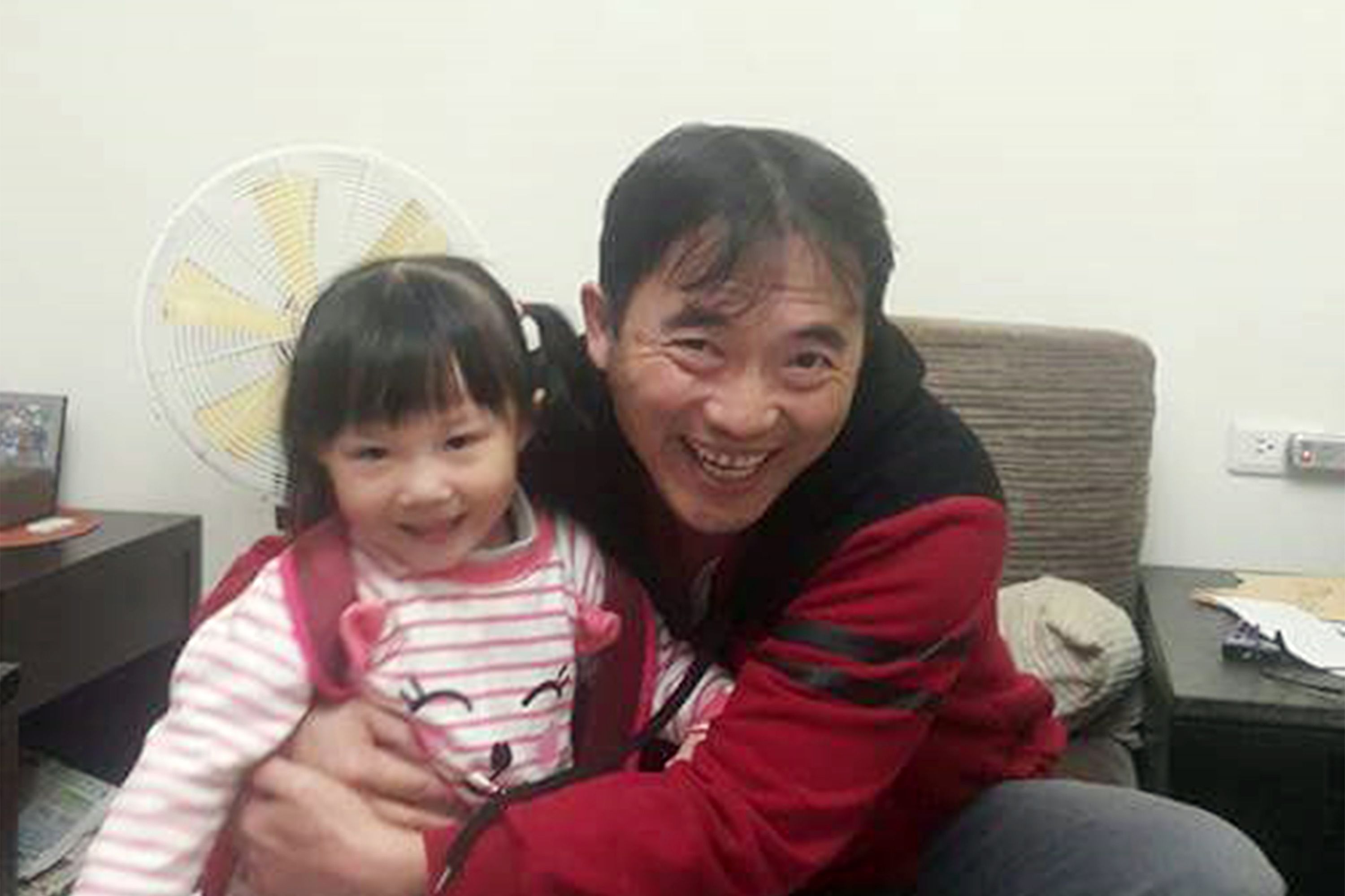 A person sitting on a couch with a child.