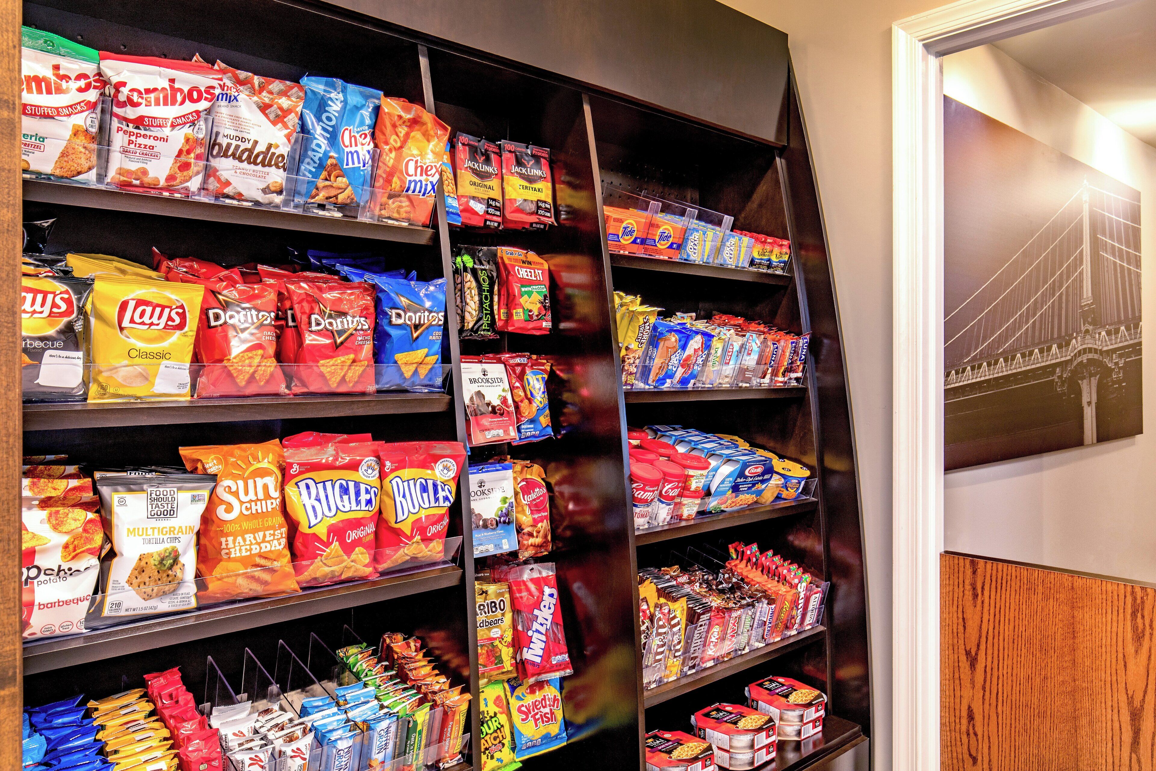 A snack aisle with various brands and types of chips and snacks.