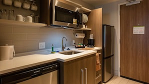 A modern kitchen with stainless steel appliances, a dishwasher, and a wooden cabinet. - Home2 Suites by Hilton Nashville Bellevue (Nashville)