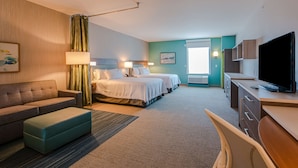A hotel room with two beds, a sofa, a desk, a TV, and a window. - Home2 Suites by Hilton Nashville Bellevue (Nashville)
