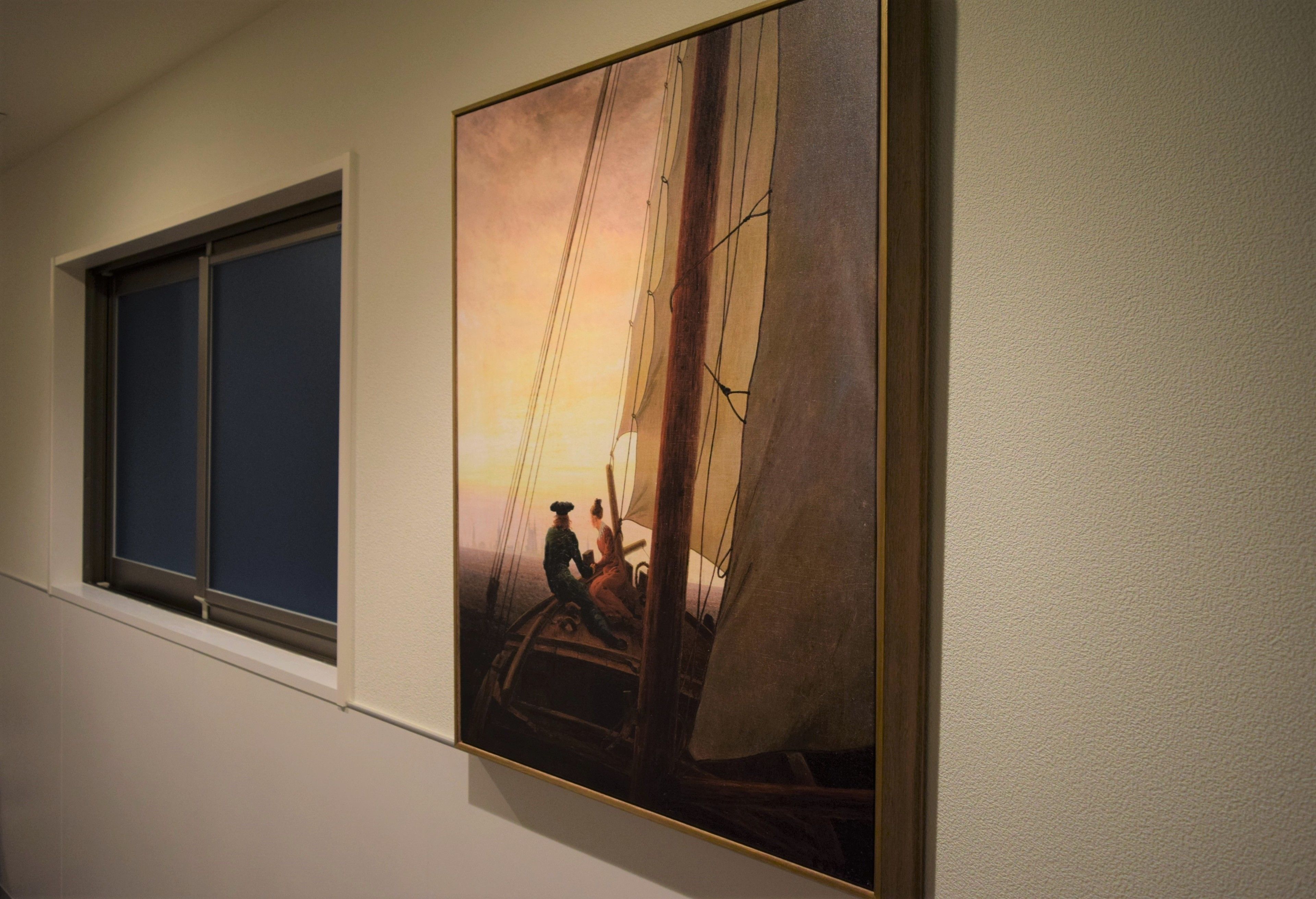 A painting of a sailing ship on a wall.