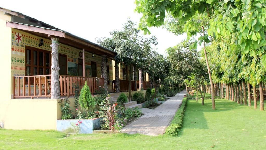 A building with a traditional architectural style, featuring a wooden facade and a covered porch area.