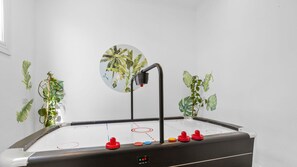 A table hockey game with a digital scoreboard and a wall with plant illustrations. - Como Palm Retreat Rye Holiday Home with Pool (Rye)