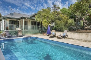 A swimming pool with lounge chairs and a covered patio area. - Poolside Sorrento Pet Friendly (SORRENTO)