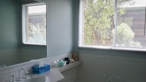 A bathroom with a white sink, a bathtub, and a window with blinds. - Blairgowrie Relaxation (BLAIRGOWRIE)