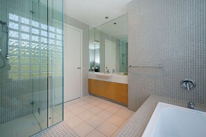 A modern bathroom with a glass shower enclosure, a large mirror, and a bathtub. - Diamond View Sorrento Holiday Home with Pool (Sorrento)