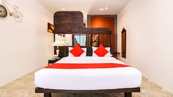 Una habitación de hotel moderna con una cama grande, una pared decorada con ladrillos y una bicicleta como adorno en la pared.
