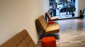 A modern interior with a sofa and ottoman in a neutral color scheme. - The Capsule Hotel (Colombo)