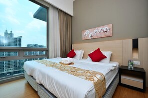 A modern hotel room with a large bed, a view of the cityscape, a painting on the wall, and a nightstand with a vase. - D'Home Stay at Swiss Garden Residence (Kuala Lumpur)