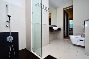 A modern bathroom with a glass-enclosed shower, a white sink, and a toilet. - D'Home Stay at Swiss Garden Residence (Kuala Lumpur)