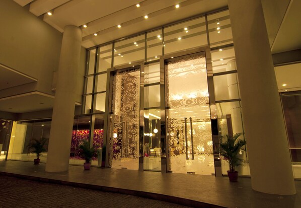 A hotel entrance with large glass doors, columns, and potted plants. - D'Home Stay at Swiss Garden Residence (Kuala Lumpur)