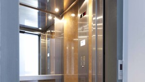 An elevator with metallic walls and a control panel. - CHROMA Lodge Pikermi  (Rafina-Pikermi)