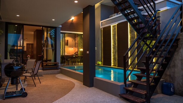 Ein modernes Interieur mit Pool, Sitzgelegenheiten im Freien und einer Treppe.
