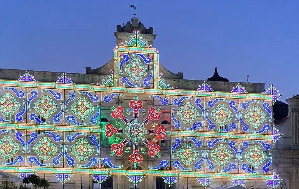 A building facade with intricate geometric patterns and a central decorative element.