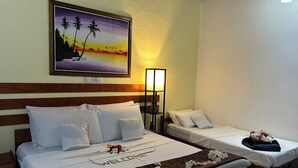 A hotel room with two beds, a nightstand, a wall-mounted painting, and a bedside table with a lamp. - Goby Lodge Guest House (Mahibadhoo)