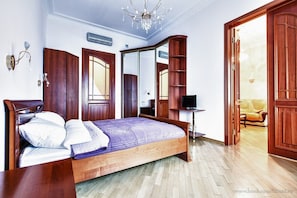Relax in this inviting bedroom with a large bed, television, and ample storage space.