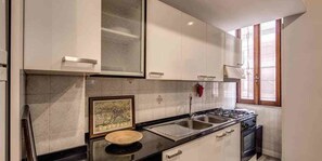 Apartment, 1 Bedroom | Private kitchen | Full-size fridge, oven, stovetop, cookware/dishes/utensils - Mecenate Colosseum Suite (Rome)