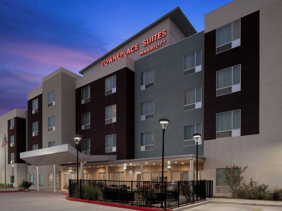 A multi-story hotel with a modern design, featuring a prominent sign for 'Towneplace Suites Marriott'.