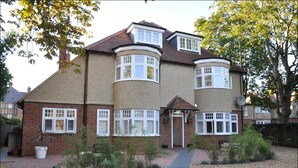 A two-story house with a curved bay window, a brick facade, and a small front porch. - HomefromHolme Alban House (St Albans)