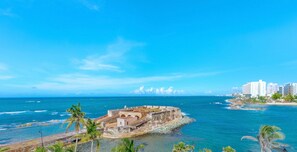 A coastal fortification with a clear view of the ocean and a distant cityscape. - 510 Ocean Studio (San Juan)