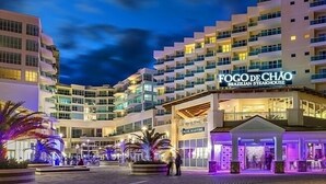 A multi-story hotel with a prominent Brazilian steakhouse sign. - 619 Breezy Studio (San Juan)
