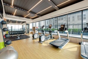 A modern gym with treadmills, elliptical machines, and free weights. - DoubleTree by Hilton Taipei Zhongshan (Taipei)