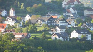A residential area with houses and a church. - Garni Hotel & Ferienwohnungen Seeschlößchen (Waldeck)