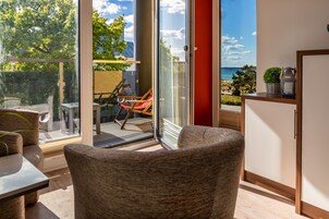 Double Room, Balcony, Partial Sea View (Nr. 8) | Living area | Flat-screen TV, books