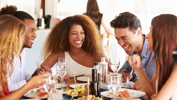 A group of people dining at a table with various dishes, glasses, and cutlery. - Remarkable One Bedroom Suite (Boston)