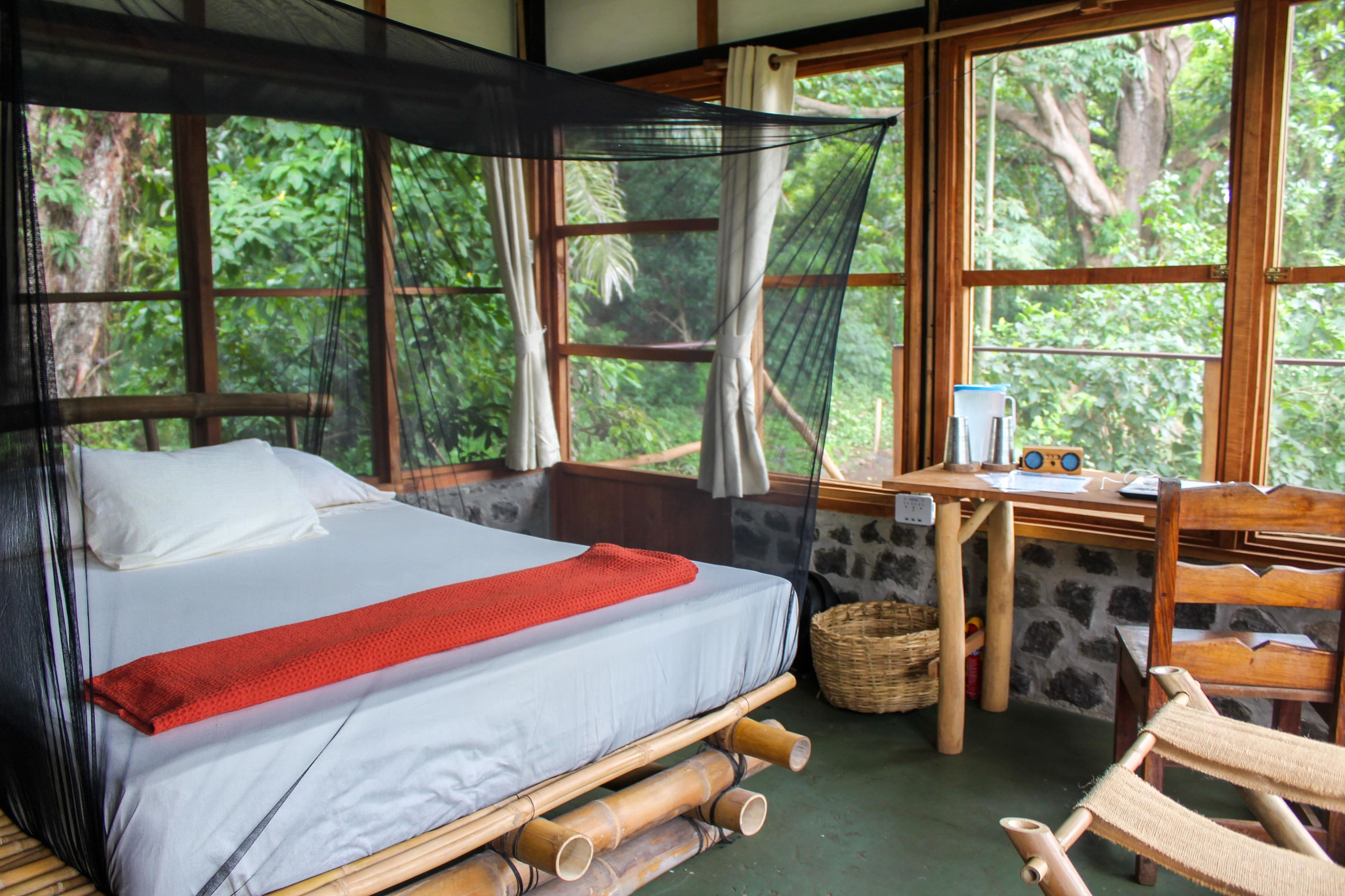 A room with a bed, a desk, and a chair.