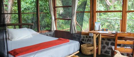 A room with a bed, a desk, and a chair.