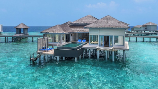 Overwater bungalows with infinity pools, wooden walkways, and clear turquoise water. - The Halcyon Private Isles Maldives, Autograph Collection (Meradhoo)