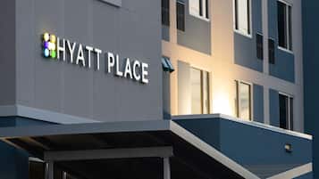 A modern building with the sign "HYATT PLACE" indicating a hotel.