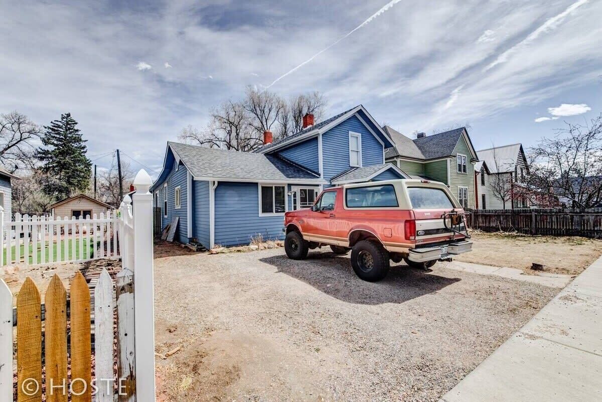 A house with a driveway and a parked red truck.